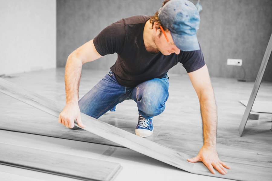 Worker installing commercial flooring