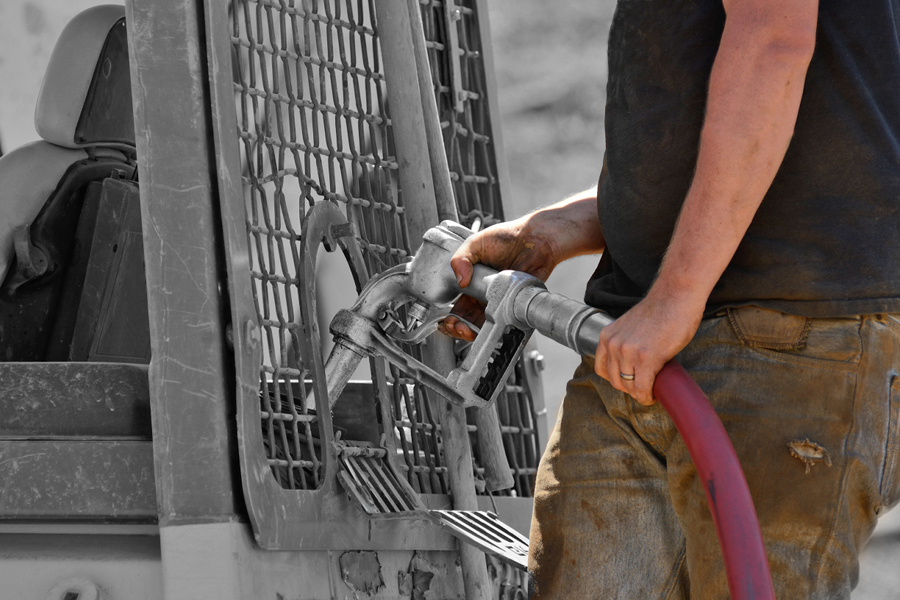 Worker refuels some construction equipment