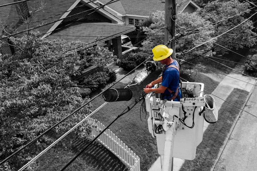 a man in a bucket fixes power lines