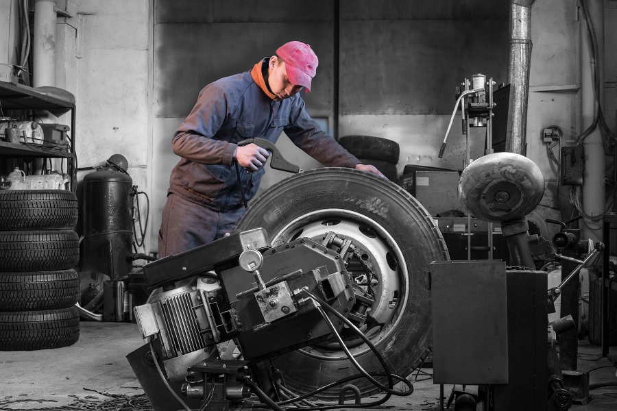 a man works over a large tire